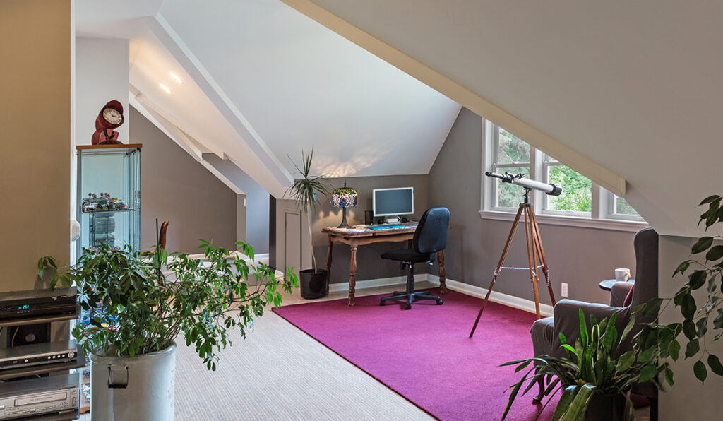 Remodeled upstairs bonus space with angled ceilings, light wood floors, and recessed lighting.