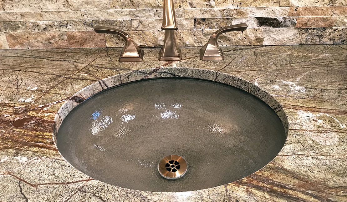 Sink with copper faucet in master bath remodel in Muskego
