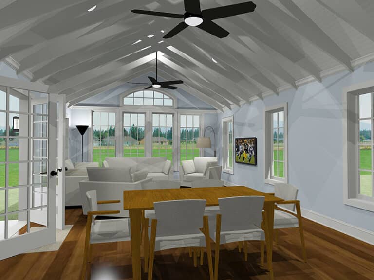A cozy living room with vaulted ceiling, two ceiling fans, large windows, wooden table, and modern sofas. A TV displays a sports game.