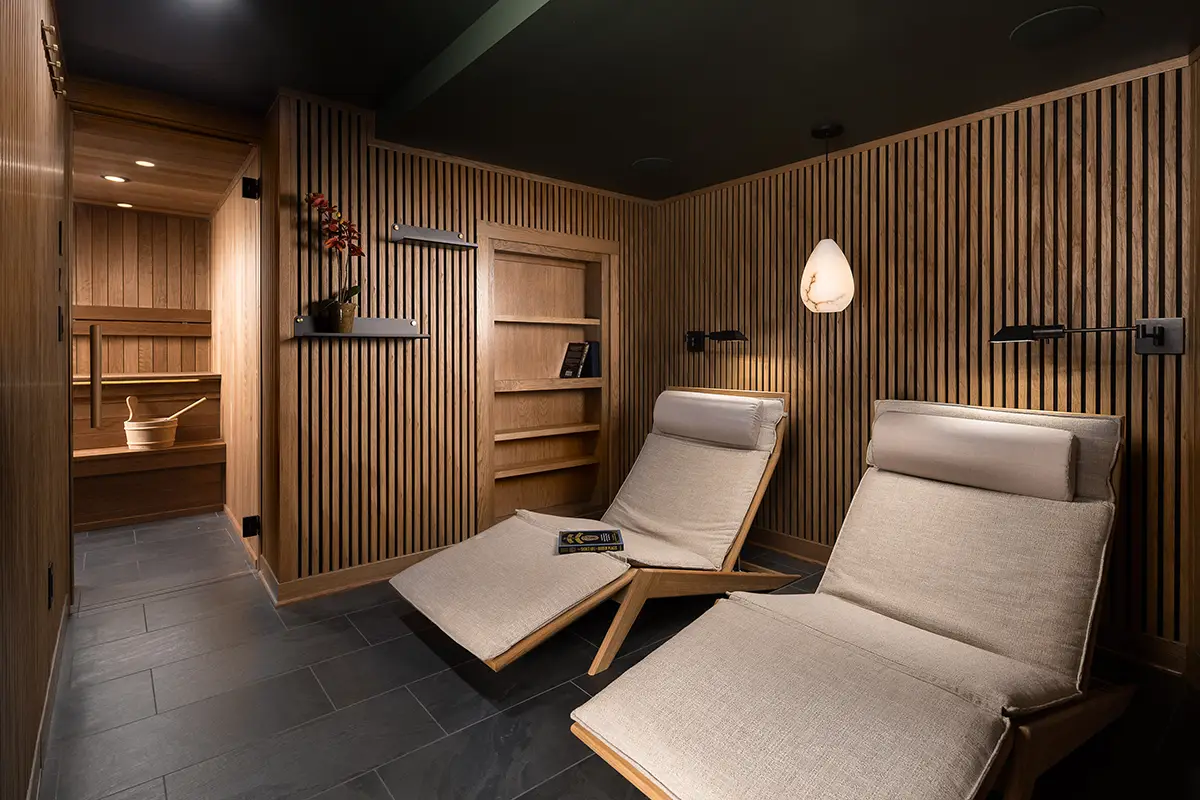 Modern sauna in Whitefish Bay basement remodel – custom wood interior, bench seating & spa design