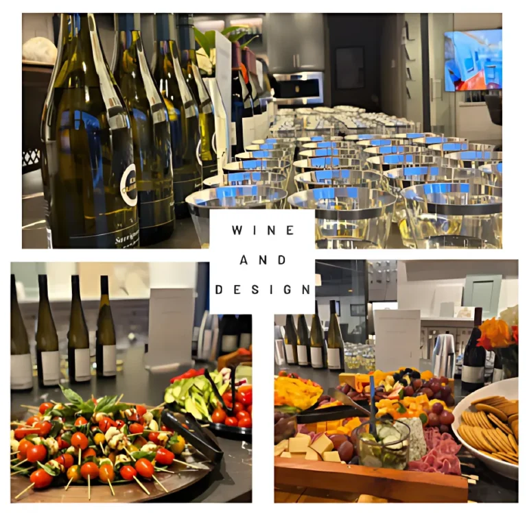 Wine bottles, glasses, and a variety of appetizers on a table for a "Wine and Design" event in a modern, stylish setting.