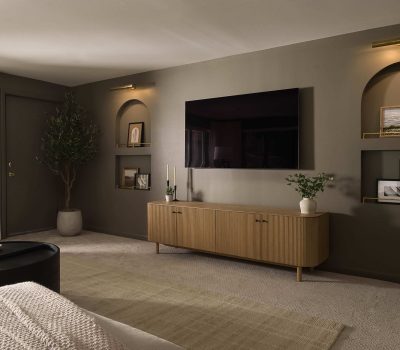 A modern living room with a large TV, wooden cabinet, and decorative shelves. Soft lighting and plants create a cozy atmosphere.